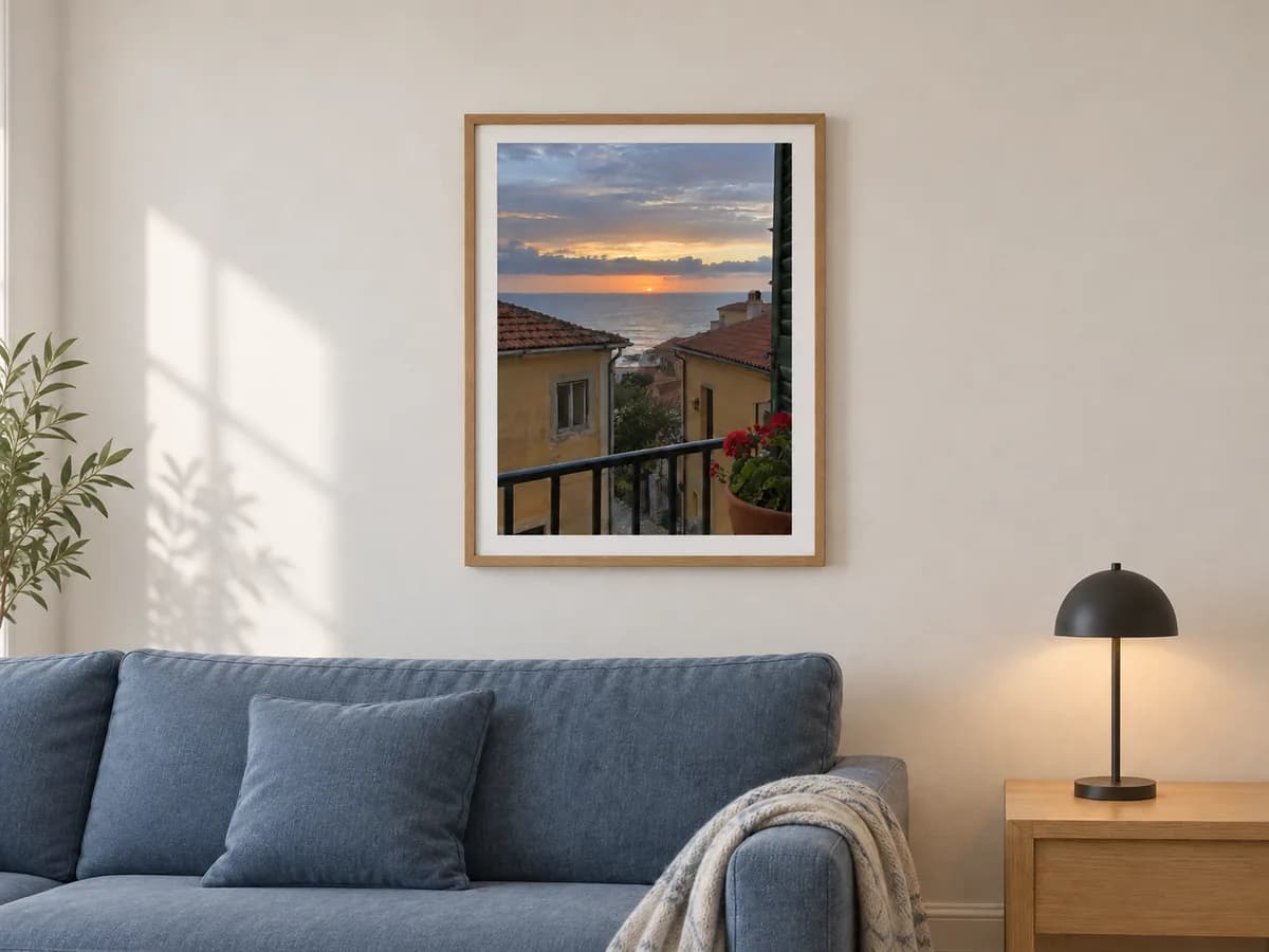 The coastal sunset photo in a natural frame above a blue sofa