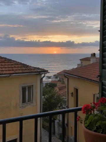 Coastal rooftops and the sea at sunset