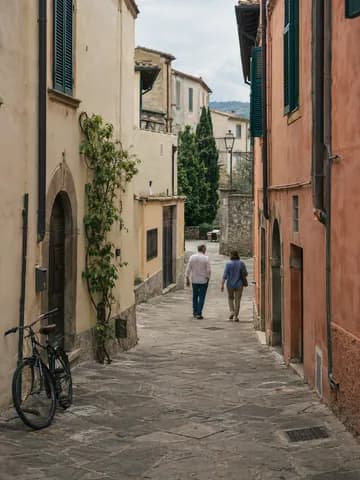Two people walking along a quiet Italian street